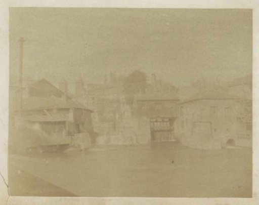View of a village with watermills, probably in France