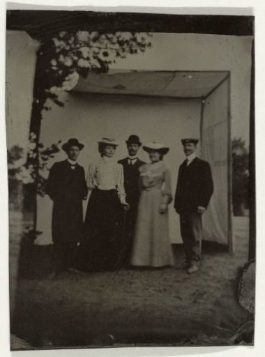 Two women and a man posing in a ferrotype tent