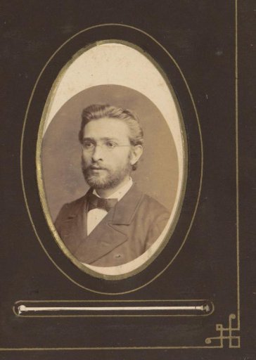 Portrait of a young man with a beard and spectacles