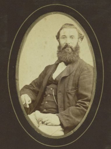 Portrait of a man with a cigar in his hand, seated