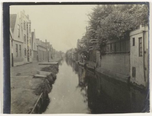 View in a Village, with Houses on Both Sides of a Waterway