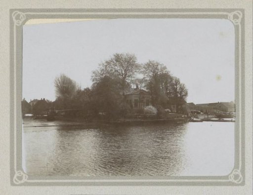 House among the trees by the water