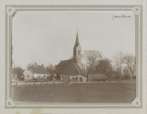 Houses and a church tower in IJsbrechtum