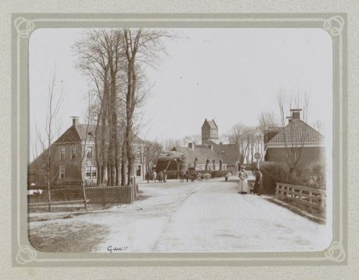 Horse-drawn cart and villagers in a street in Gauw, with a church tower in the background
