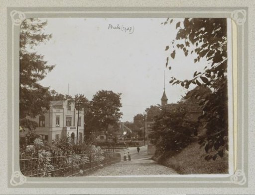 Village Street with Houses and Passersby in Beek (Gelderland)