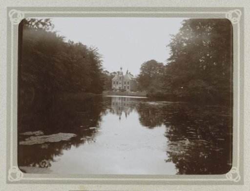 Castle by a water in a wooded environment