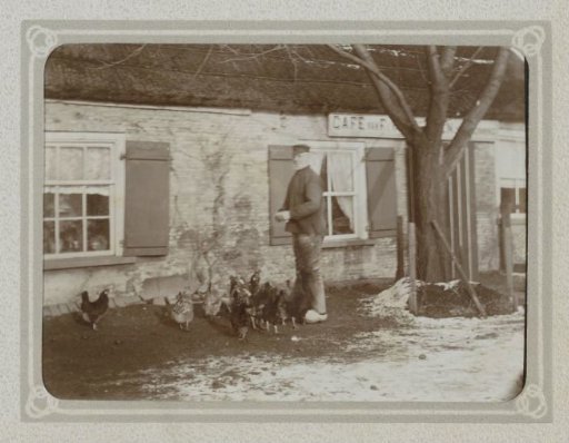 Man leading chickens past a café