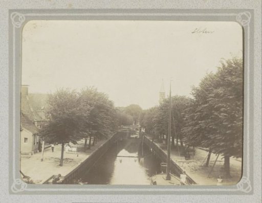 Canal in Sloten (Friesland), with a church tower on the horizon