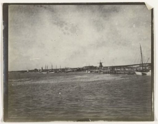 View of a river or the Zuiderzee, with a bridge and a windmill in the background, Netherlands