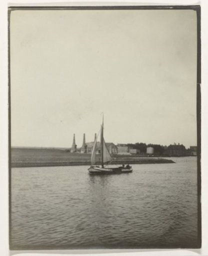View of a river, Netherlands, with a sailing ship and lime kilns in the background