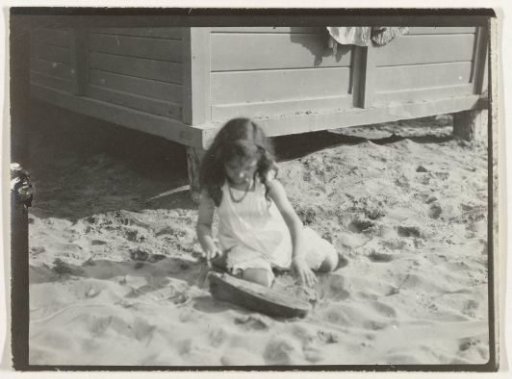 Girl playing on the beach (North Sea coast), Netherlands or Germany