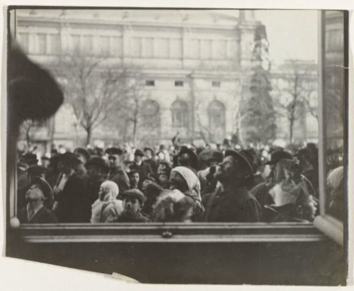 Crowd of people seen through the window of a house