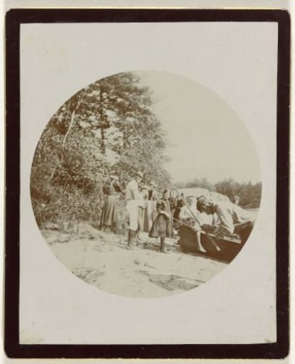 Company fishing at the edge of a lake or river