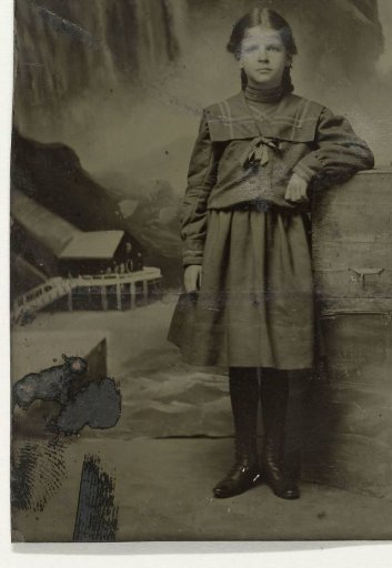 Portrait of a girl before a painted backdrop with Niagara Falls