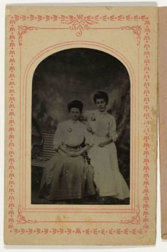 Portrait of a woman and a girl in front of a painted backdrop