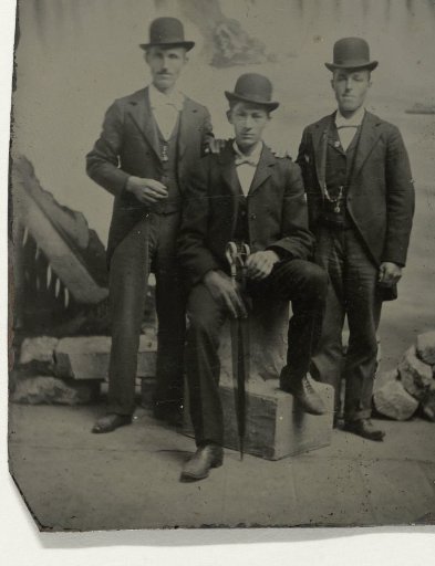 Portrait of Three Men Before a Painted Backdrop Depicting Niagara Falls