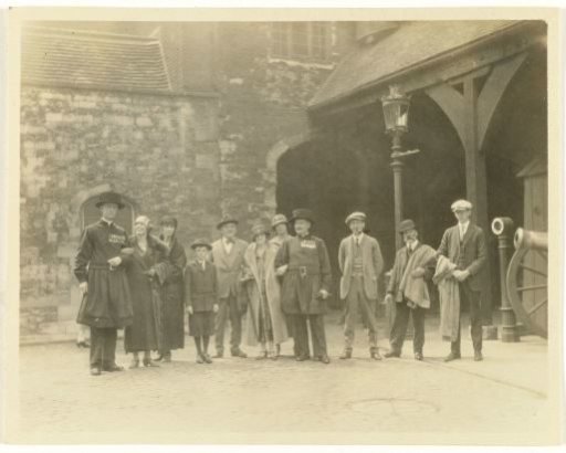 Group of American tourists at a castle, with a Beefeater (?), England