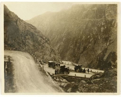 Group of American tourists with their cars in the Alps