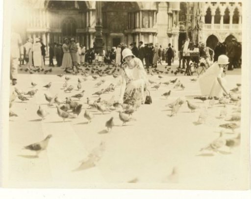 American tourists feeding pigeons on Piazza San Marco in Venice