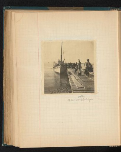 Dina (Dolly) Amelia van Emden standing on a pier with a moored steamship in Chiavari