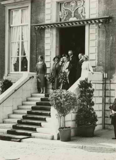 Queen Wilhelmina and Queen Mother Emma watching the folkloristic parade in Arnhem from a platform