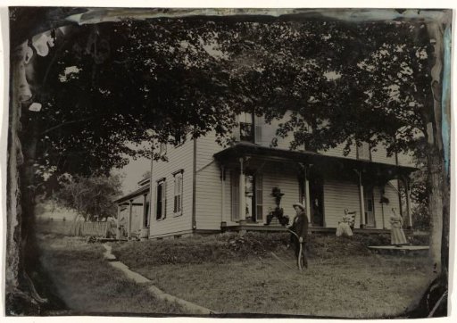 Inhabitants in front of their wooden house