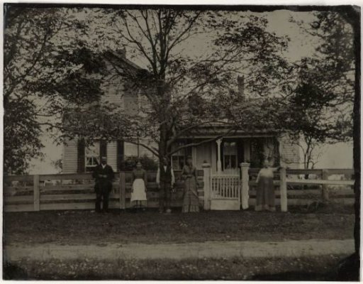 Inhabitants in Front of Their Wooden House