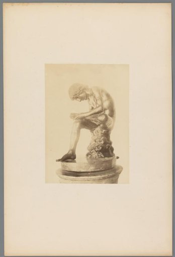 Sculpture of a Figure Looking Beneath His Feet