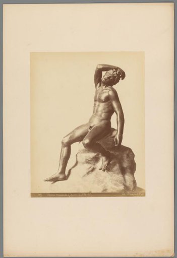 Sculpture of a seated man on a rock