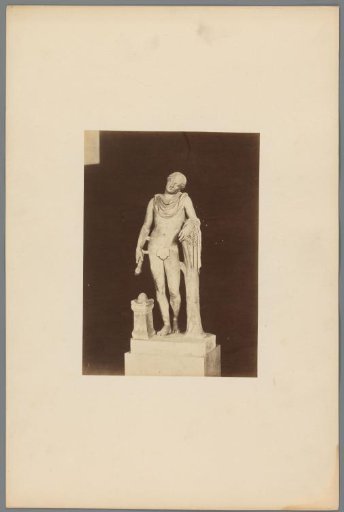 Sculpture of a figure holding branches