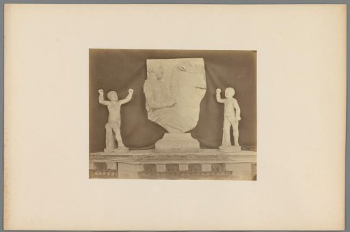 Two sculptures of children and a relief of a part of a man on horseback