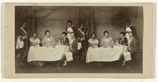 Theatre company at table, with two servants or waiters on either side