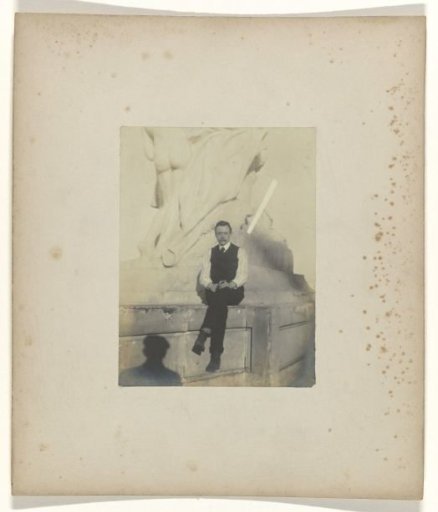 Jan Catharinus Schüller seated on the pedestal of a sculpture on the grounds of the World's Fair in St. Louis (Louisiana Purchase Exposition), 1904
