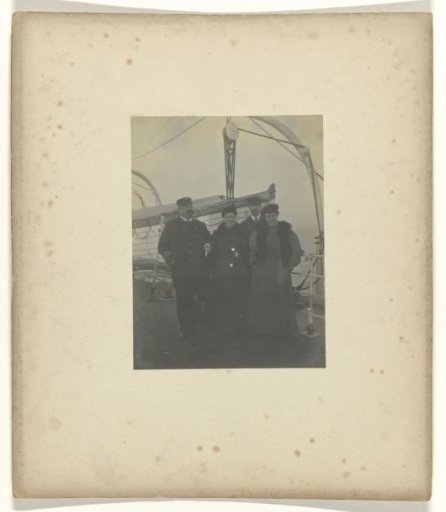 Group portrait of two men and two women on the deck of a ship