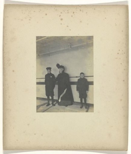 A woman and two boys on the deck of a ship