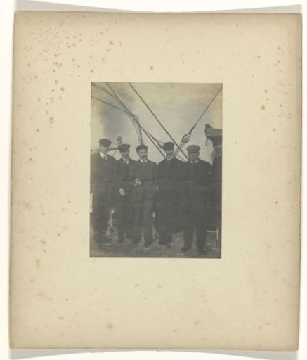 Group portrait of six men on the deck of a ship, with Jan C. Schüller on the far left