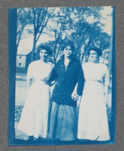 Three young women, possibly on the campus of St. Johnsbury Academy in Vermont