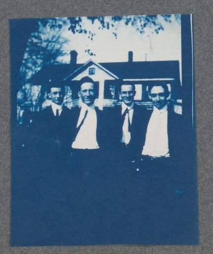 Four young men, possibly on the campus of St. Johnsbury Academy in Vermont