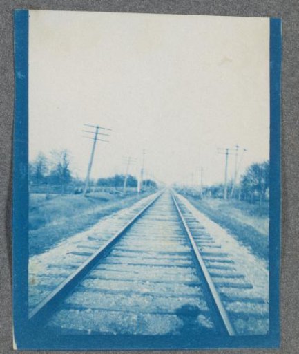 Railway track, with the photographer's shadow at the bottom