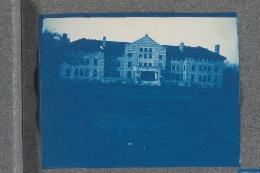 Building on a grassy field, possibly on the campus of St. Johnsbury Academy in Vermont