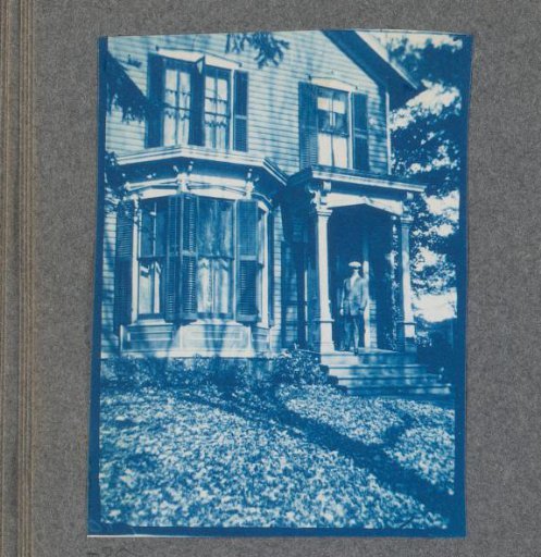 Young man in front of a house, possibly on the campus of Denison University in Ohio