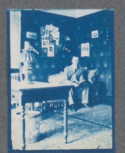 Student in his student room, possibly on the campus of Denison University in Ohio