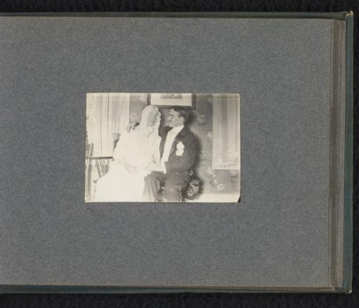 Seated bridal couple, possibly two male students at a costume party