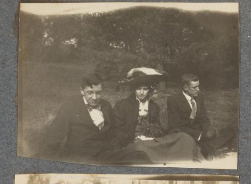 Two young men and a woman on a grassy field