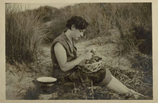 Woman peeling potatoes in the dunes