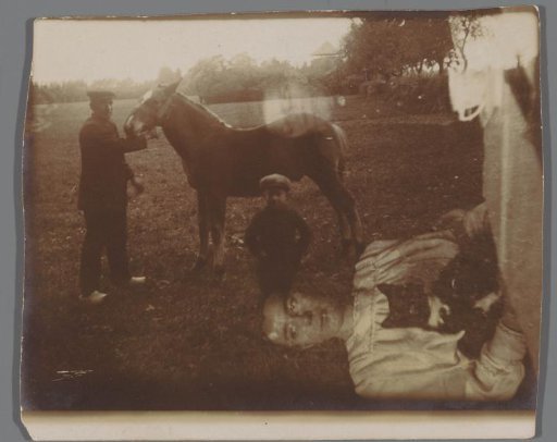 Father and son with horse, and two women with cat