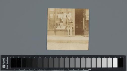 Man standing in front of his shop, Gannat (Allier), France
