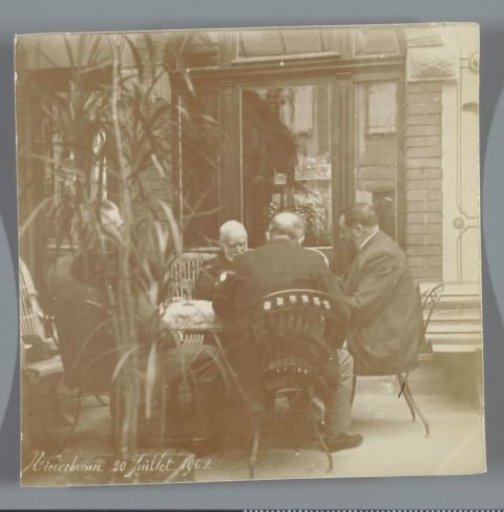 Four men sitting around a table, Niederbronn (Bas-Rhin), France