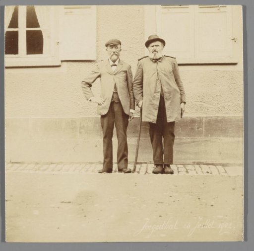 Two men standing in front of a house, Jaegerthal (Bas-Rhin), France