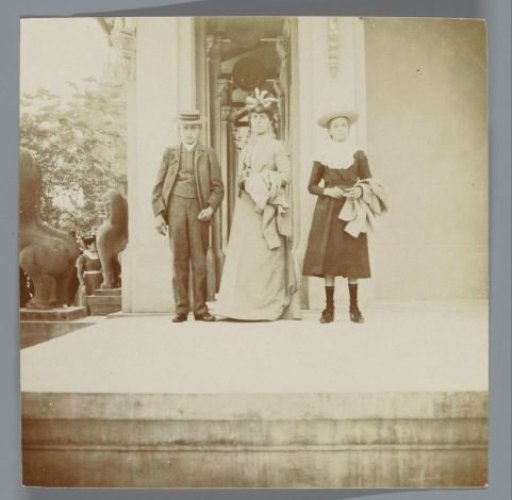 Woman, boy, and girl, very likely standing before a pavilion at the Exposition Universelle (World's Fair), Paris, France